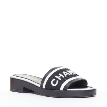Women's Chanel black white logo embroidered lambskin heeled mules
