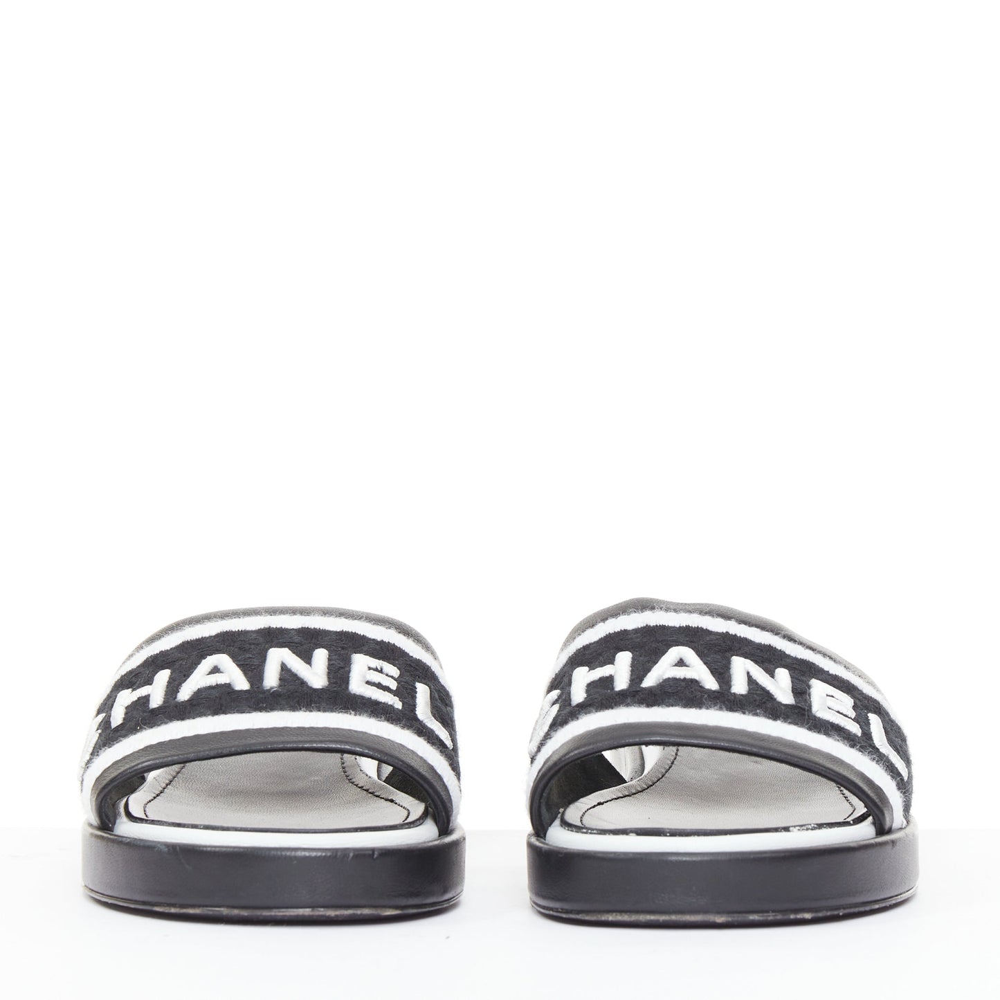 Women's Chanel black white logo embroidered lambskin heeled mules