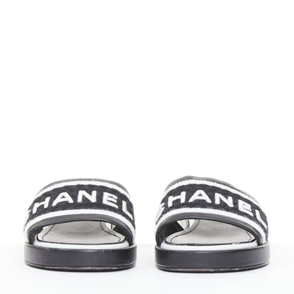 Women's Chanel black white logo embroidered lambskin heeled mules
