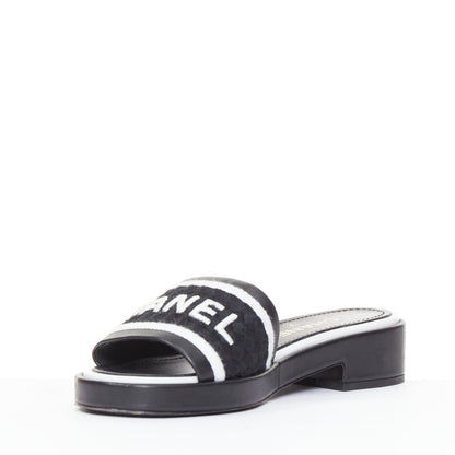 Women's Chanel black white logo embroidered lambskin heeled mules